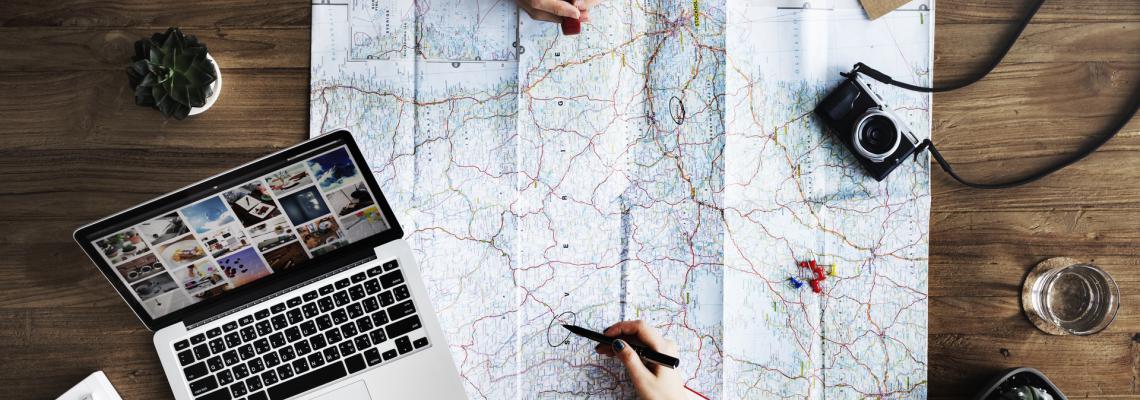 Picture of travel planning with map, computer, compass, etc