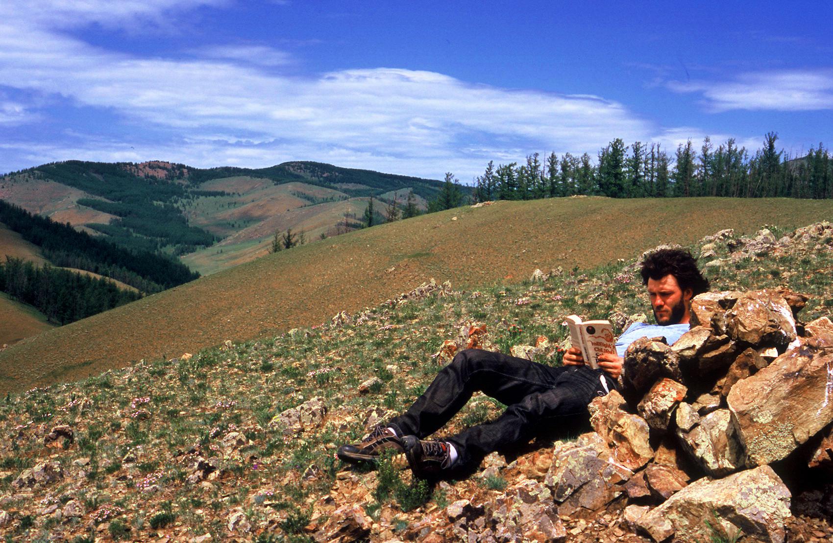 Taking a reading break on a day off from riding.